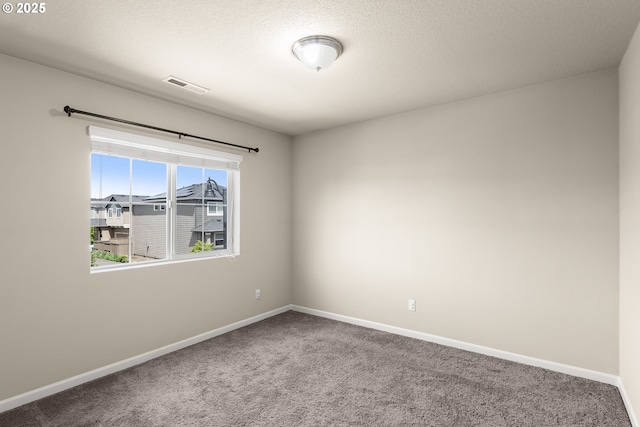 carpeted spare room with baseboards