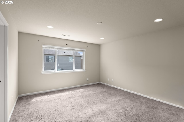 carpeted empty room with recessed lighting and baseboards