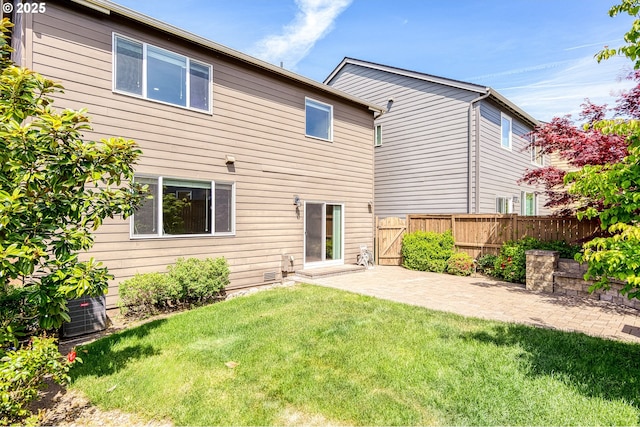 back of property featuring a patio area and a gate
