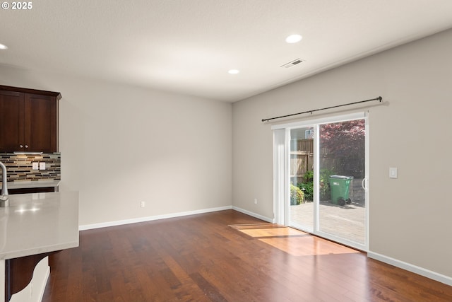 spare room with wood finished floors, recessed lighting, and baseboards