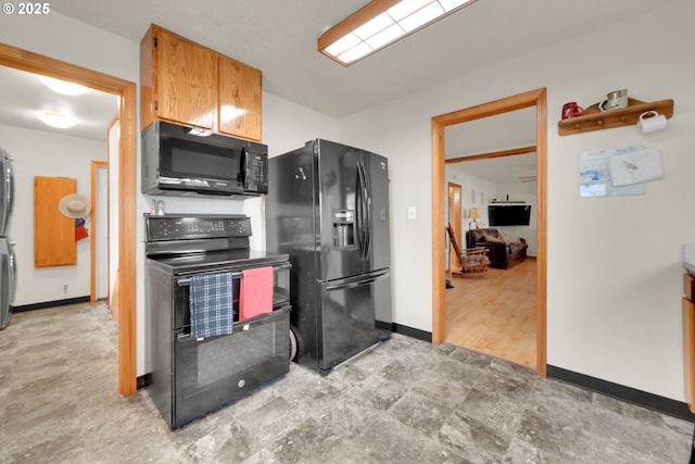 kitchen with baseboards, brown cabinets, and black appliances