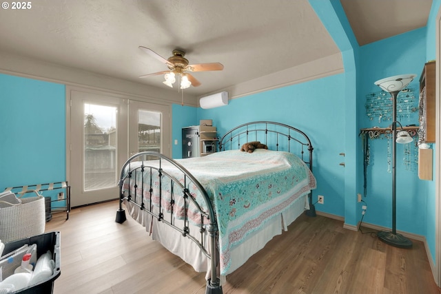 bedroom with ceiling fan, baseboards, access to outside, and wood finished floors