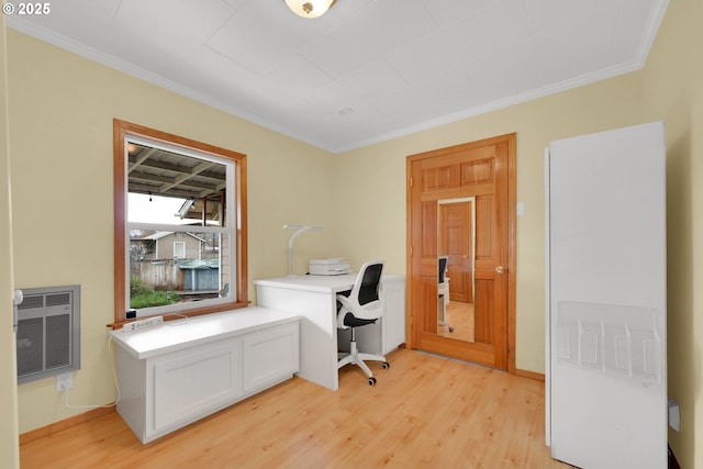 home office with ornamental molding, light wood-style flooring, and heating unit