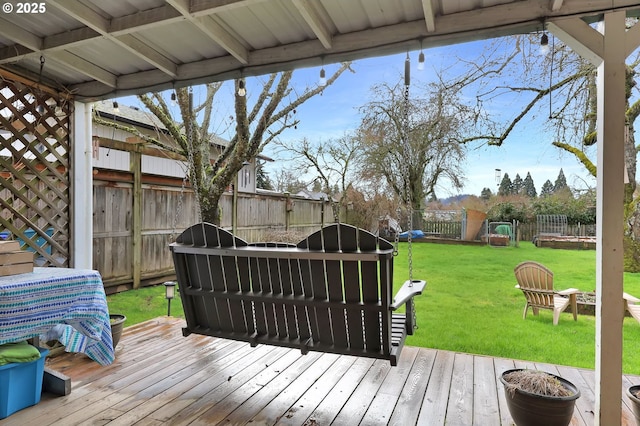 wooden deck featuring a yard and a fenced backyard