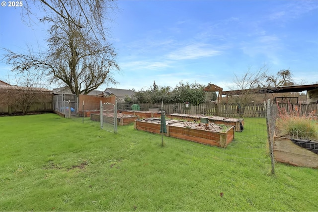 view of yard featuring a fenced backyard and a vegetable garden