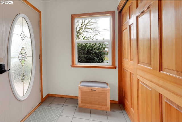 foyer entrance featuring light tile patterned floors and baseboards