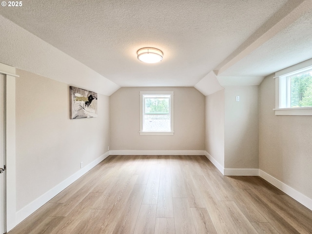 14127 SE Center St, Portland, OR 97236 - bonus room with light wood-type flooring, healthy amount of natural light, lofted ceiling, and a textured ceiling