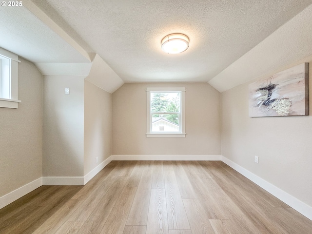 14127 SE Center St, Portland, OR 97236 - bonus room featuring light wood-style flooring, a textured ceiling, and lofted ceiling