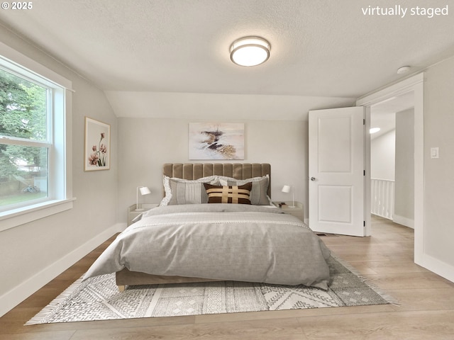 14127 SE Center St, Portland, OR 97236 - bedroom with a textured ceiling, lofted ceiling, and wood finished floors