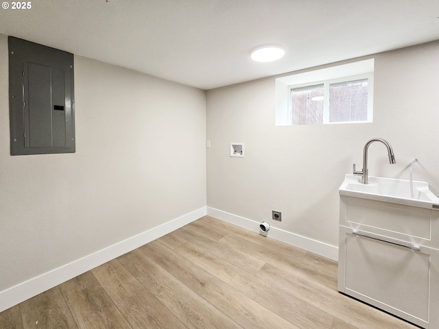 14127 SE Center St, Portland, OR 97236 - washroom with electric panel, electric dryer hookup, washer hookup, and light wood-type flooring