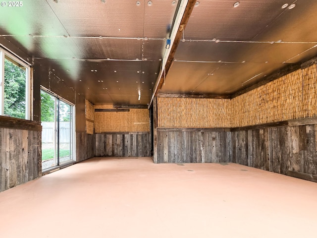 14127 SE Center St, Portland, OR 97236 - spare room with wooden walls and finished concrete flooring