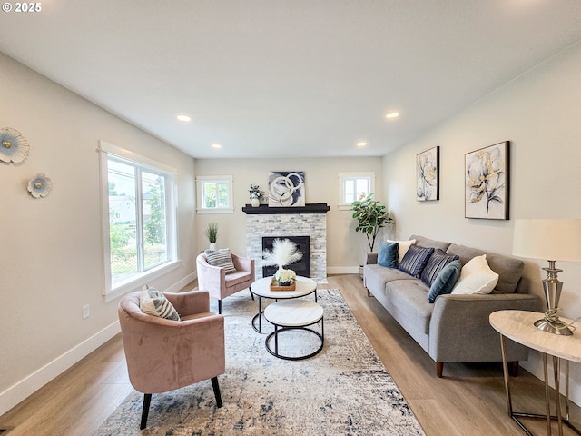 14127 SE Center St, Portland, OR 97236 - living area featuring light wood-style flooring, a stone fireplace, and recessed lighting