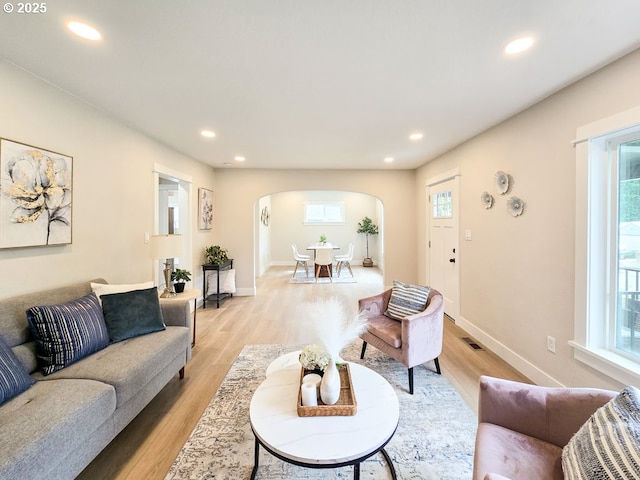 14127 SE Center St, Portland, OR 97236 - living area with arched walkways, light wood-style floors, healthy amount of natural light, and recessed lighting