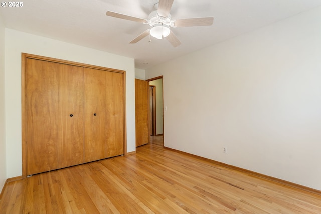 unfurnished bedroom with a closet, light wood-type flooring, baseboards, and a ceiling fan