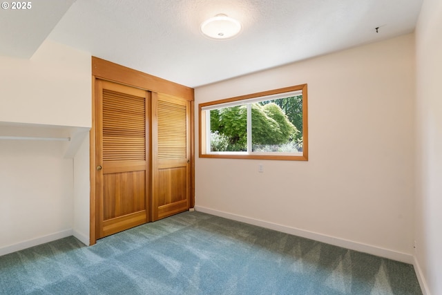unfurnished bedroom with carpet, baseboards, and a closet