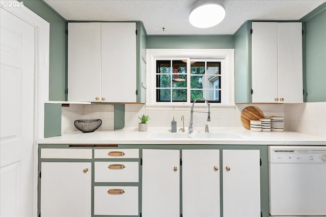 2906 SW Spring Garden St, Portland, OR 97219 - kitchen featuring dishwasher, a sink, tasteful backsplash, light countertops, and a textured ceiling