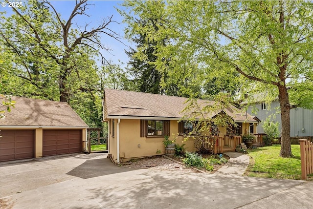 2906 SW Spring Garden St, Portland, OR 97219 - view of front facade with stucco siding, roof with shingles, and a garage