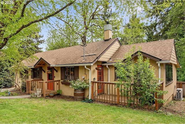 2906 SW Spring Garden St, Portland, OR 97219 - view of front facade with a chimney, a front yard, stucco siding, and a shingled roof