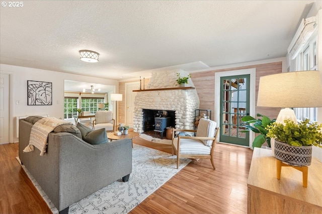 2906 SW Spring Garden St, Portland, OR 97219 - living area featuring light wood finished floors, a textured ceiling, and a fireplace