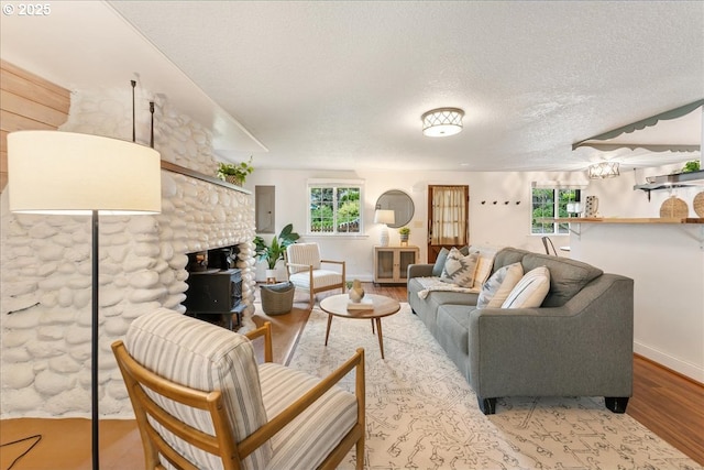2906 SW Spring Garden St, Portland, OR 97219 - living room featuring a textured ceiling, wood finished floors, healthy amount of natural light, baseboards, and electric panel