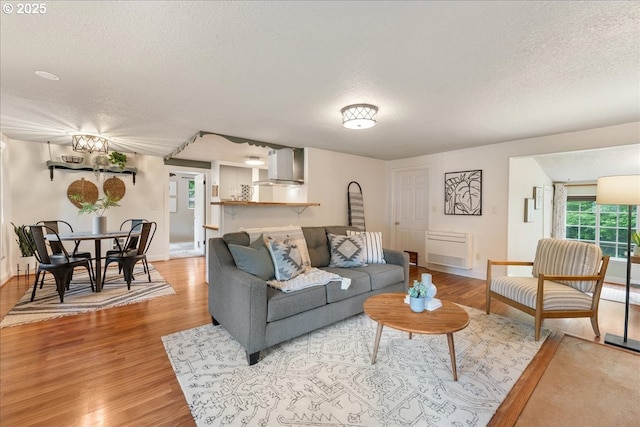 2906 SW Spring Garden St, Portland, OR 97219 - living area featuring a textured ceiling, light wood-type flooring, and baseboards