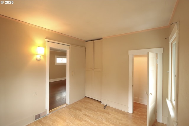 780 N 10th St, Coos Bay, OR 97420 - unfurnished bedroom featuring visible vents, light wood-type flooring, and a closet