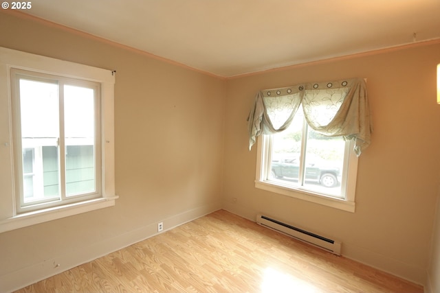 780 N 10th St, Coos Bay, OR 97420 - unfurnished room featuring light wood-style flooring, baseboards, a wealth of natural light, and a baseboard radiator