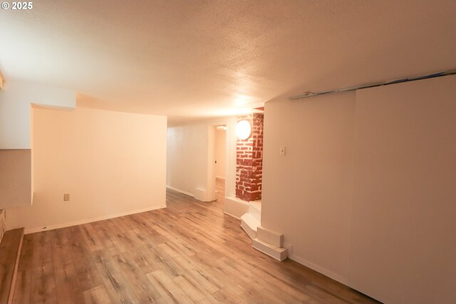780 N 10th St, Coos Bay, OR 97420 - finished below grade area featuring baseboards, wood finished floors, and a textured ceiling
