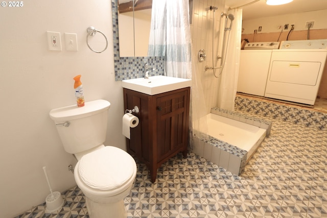 780 N 10th St, Coos Bay, OR 97420 - full bath with a shower stall, toilet, washing machine and clothes dryer, and tile patterned floors