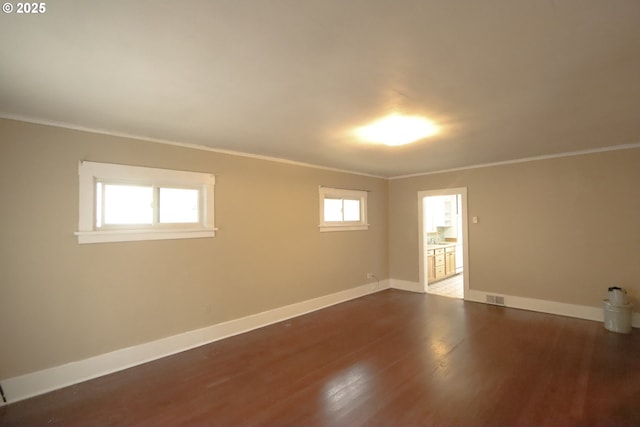 780 N 10th St, Coos Bay, OR 97420 - spare room featuring visible vents, crown molding, dark wood-style floors, and baseboards