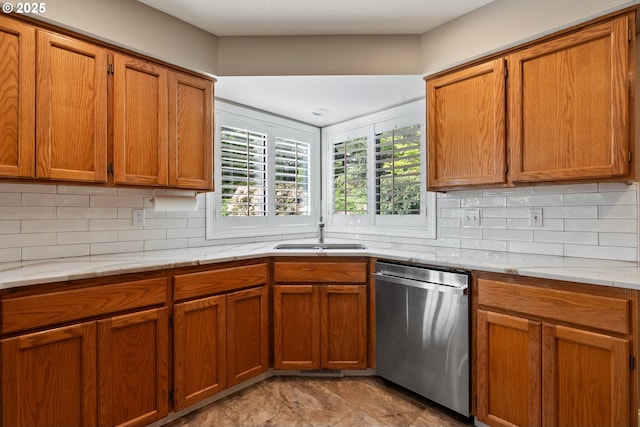kitchen with a sink, tasteful backsplash, brown cabinets, and dishwasher