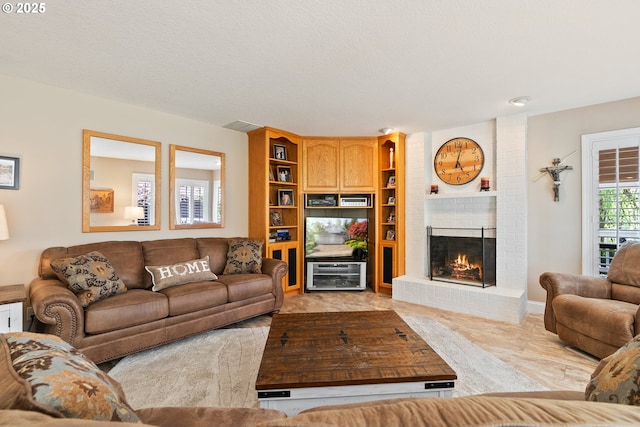 living area with a brick fireplace