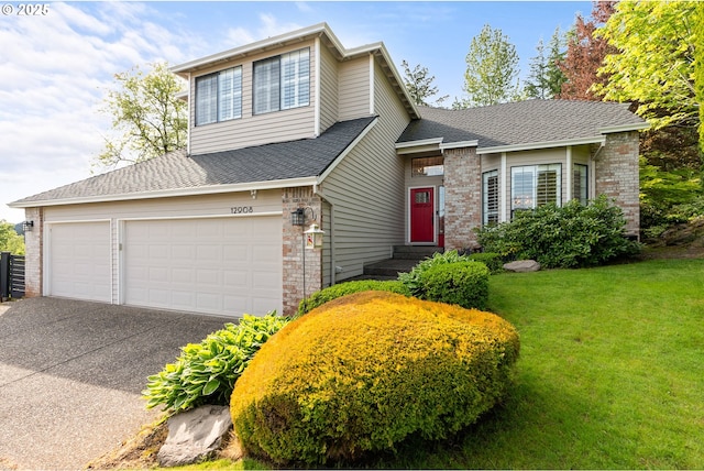 view of front of house featuring an attached garage, a shingled roof, aphalt driveway, and a front yard