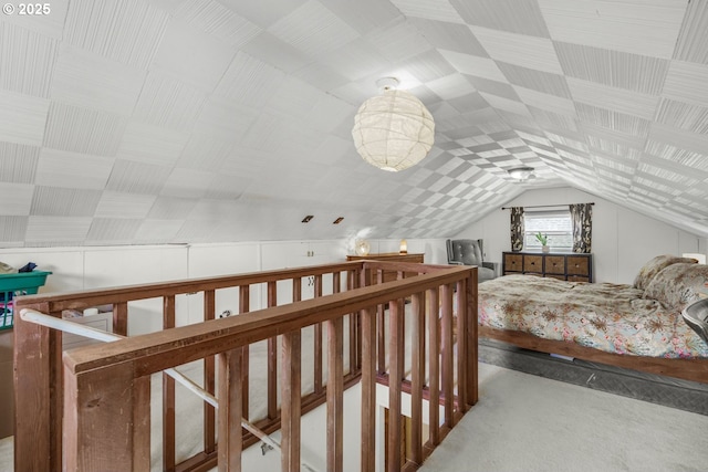 bedroom featuring vaulted ceiling and carpet floors