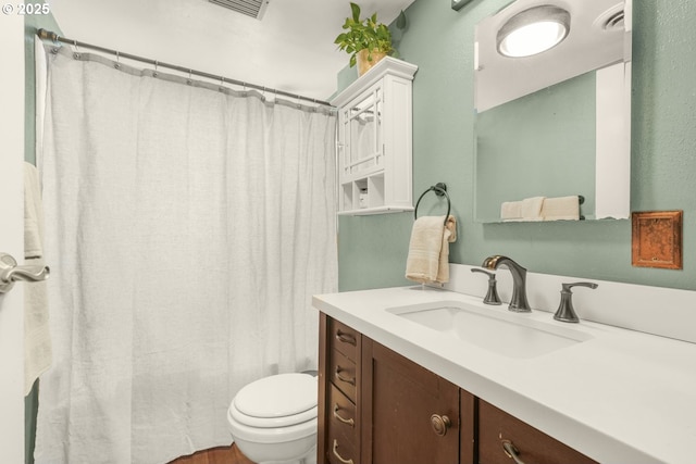 full bathroom featuring toilet, vanity, and a shower with shower curtain
