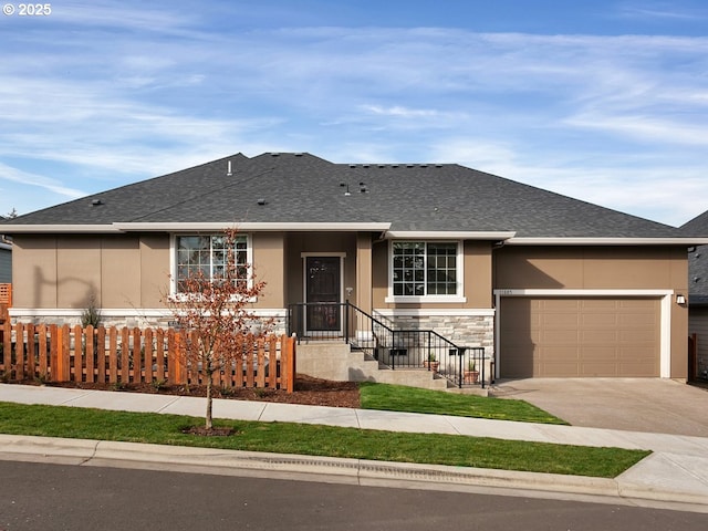 ranch-style house with stone siding, concrete driveway, stucco siding, and fence