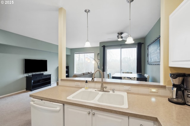 kitchen featuring dishwasher, ceiling fan, pendant lighting, sink, and white cabinetry