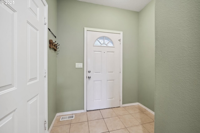 foyer featuring light tile patterned floors