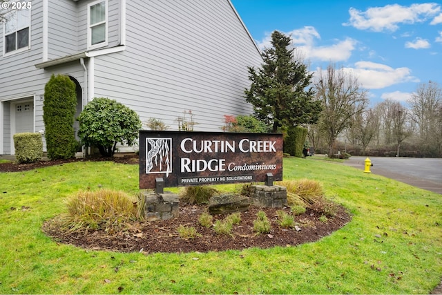 community sign featuring a yard