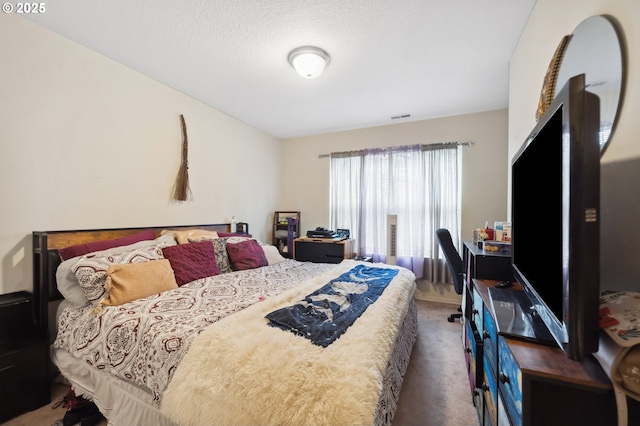 carpeted bedroom with a textured ceiling