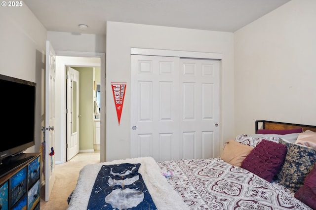 bedroom with a closet and light carpet