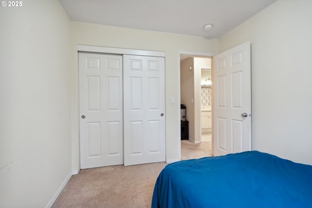 bedroom featuring light colored carpet and a closet