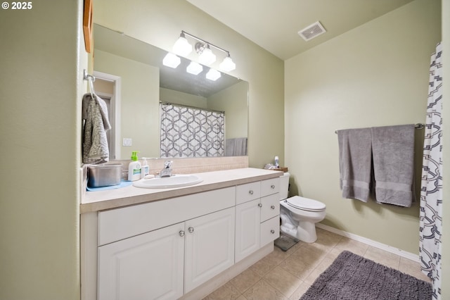 bathroom with toilet, vanity, and tile patterned flooring