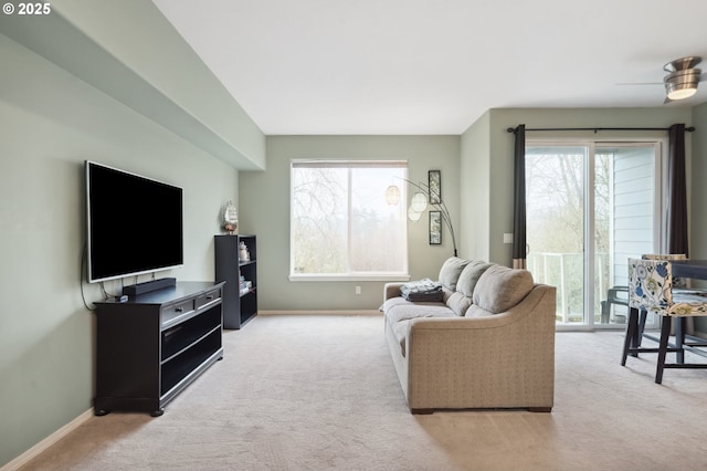 living room featuring ceiling fan and light colored carpet