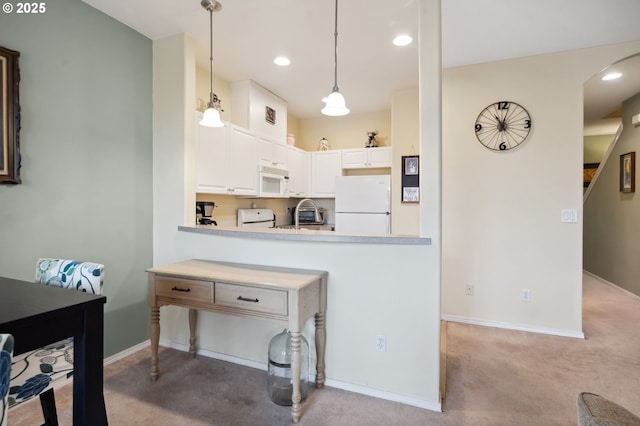 kitchen with white appliances, kitchen peninsula, decorative light fixtures, white cabinetry, and light carpet