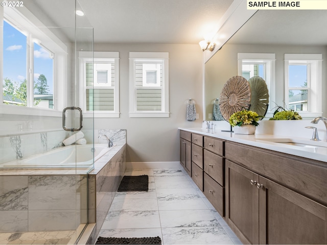 bathroom featuring vanity and shower with separate bathtub