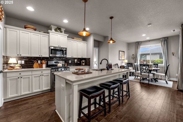 13610 NE 109th Way, Vancouver, WA 98682 - kitchen featuring appliances with stainless steel finishes, a sink, decorative backsplash, white cabinetry, and light countertops
