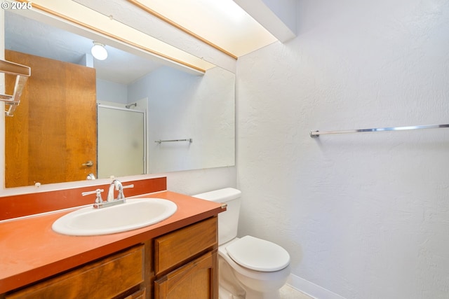 650 Harlow Rd Unit 240, Springfield, OR 97477 - bathroom featuring a shower stall, vanity, a textured wall, baseboards, and toilet