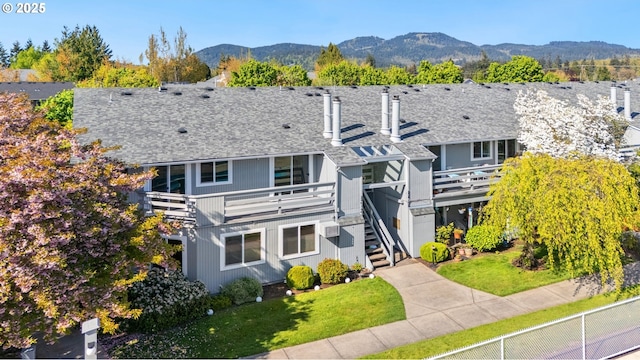 650 Harlow Rd Unit 240, Springfield, OR 97477 - exterior space with a lawn, a chimney, a deck with mountain view, a shingled roof, and stairs