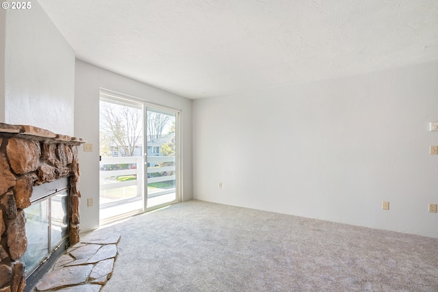 650 Harlow Rd Unit 240, Springfield, OR 97477 - unfurnished living room featuring carpet flooring and a fireplace